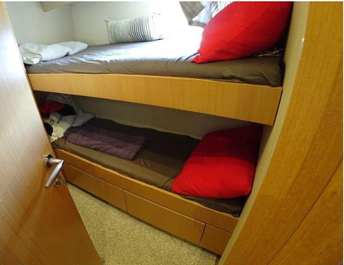 a bed with a red pillow aboard CHUPRIANA Yacht for Sale