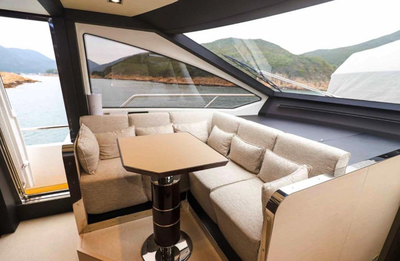 a room with a couch and a table aboard AZIMUT 80 FLYBRIDGE Yacht for Sale