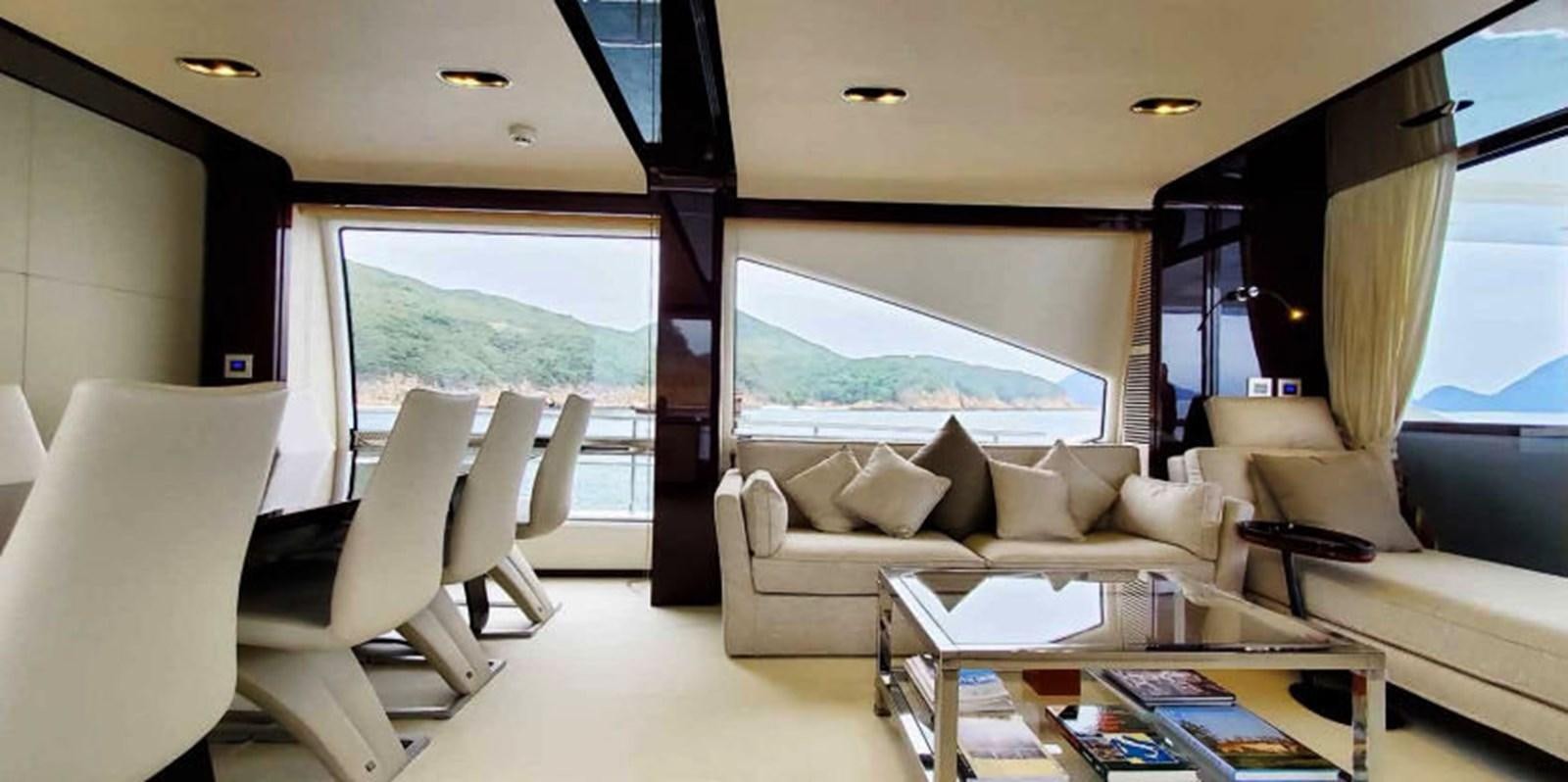 a living room with a large window aboard AZIMUT 80 FLYBRIDGE Yacht for Sale