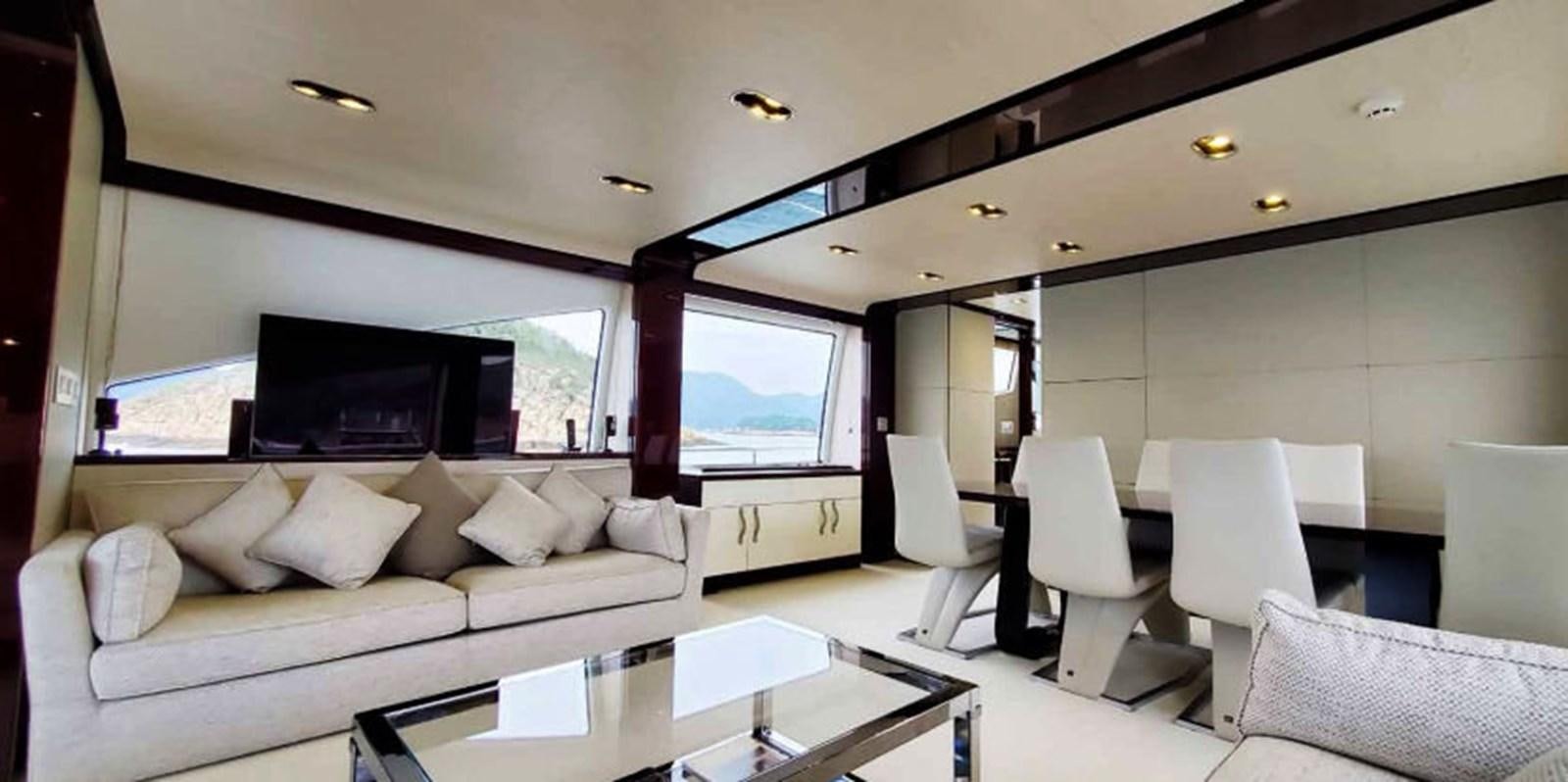 a living room with a large screen aboard AZIMUT 80 FLYBRIDGE Yacht for Sale