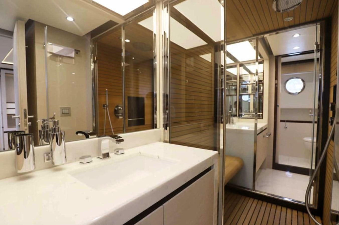 a bathroom with a large mirror aboard AZIMUT 80 FLYBRIDGE Yacht for Sale