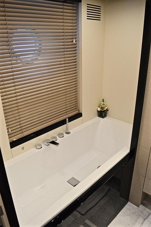 a bathtub with a window aboard MEMORIES Yacht for Sale