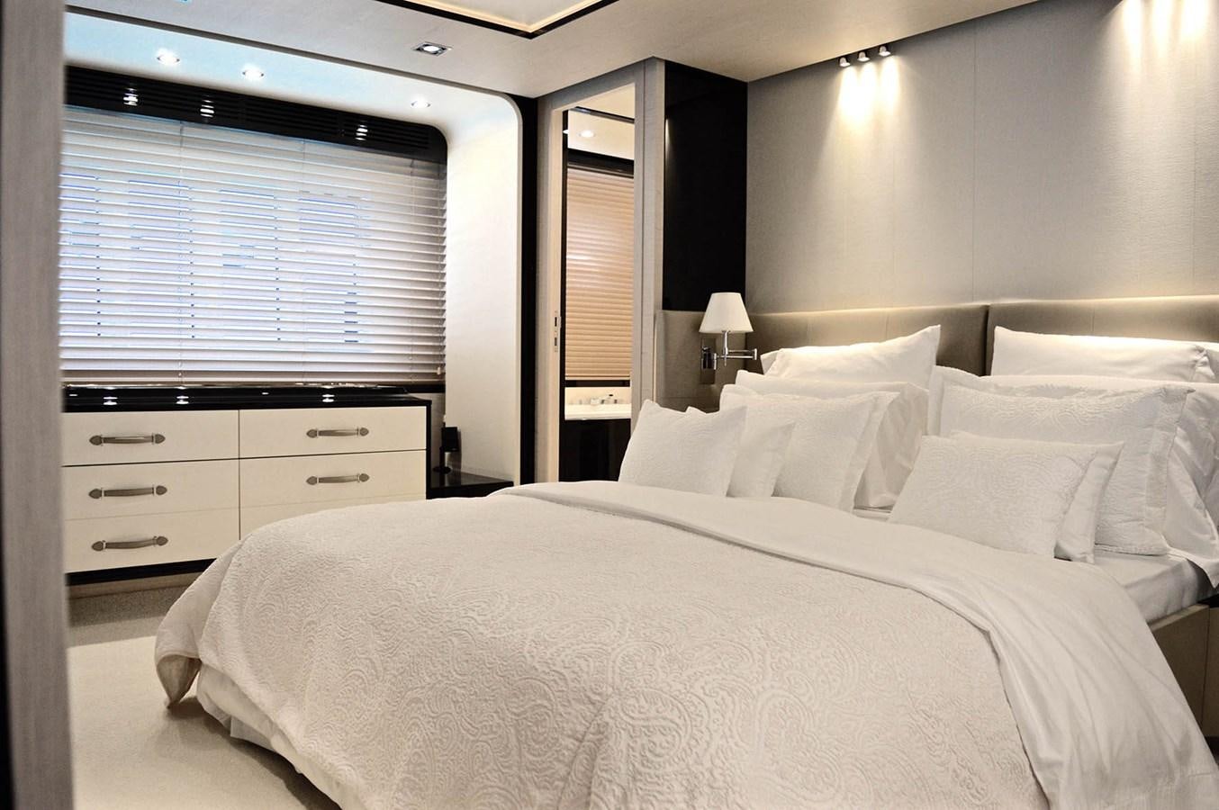 a large bed with white sheets aboard MEMORIES Yacht for Sale