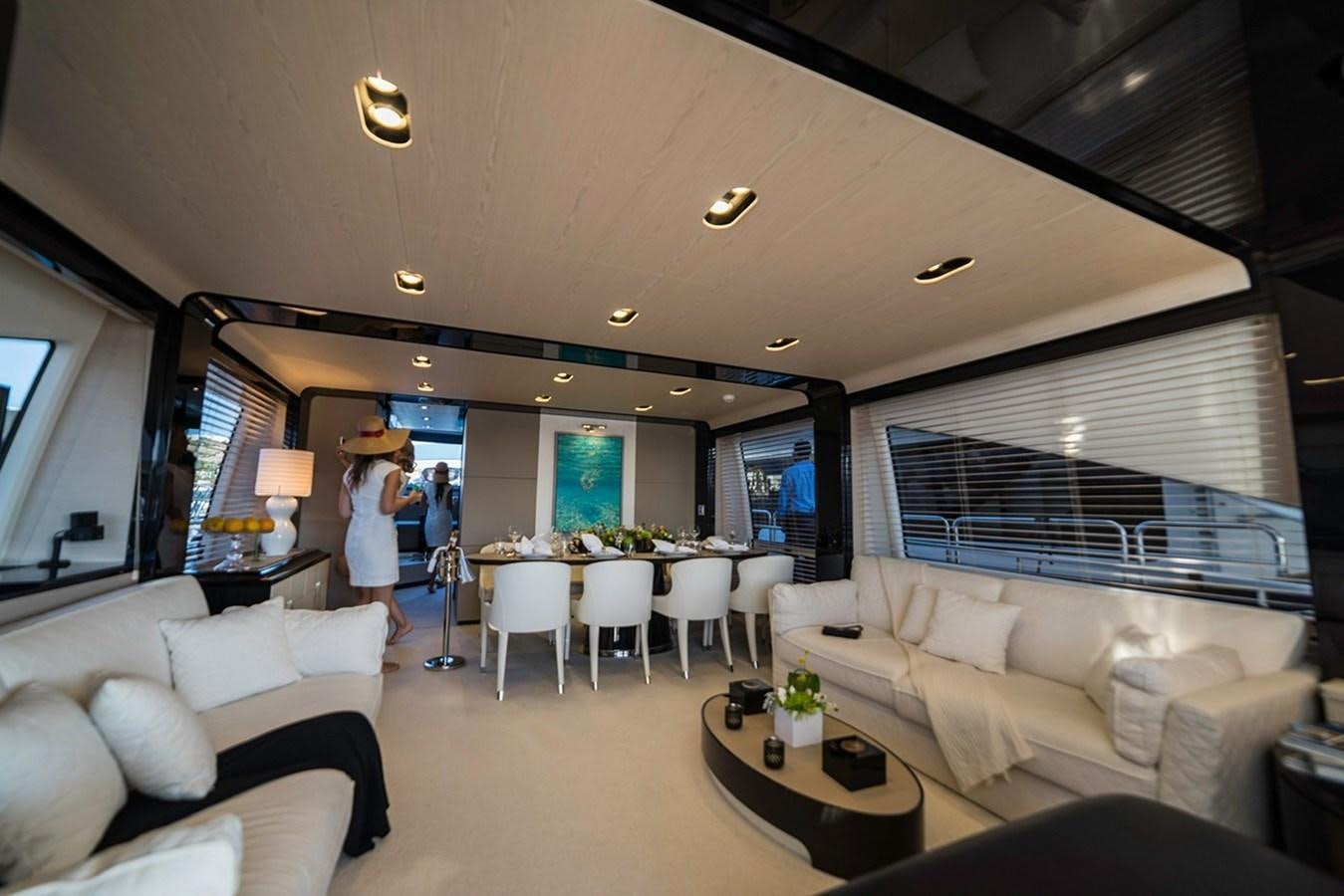 a room with a couch and a table and a couple of people aboard MEMORIES Yacht for Sale