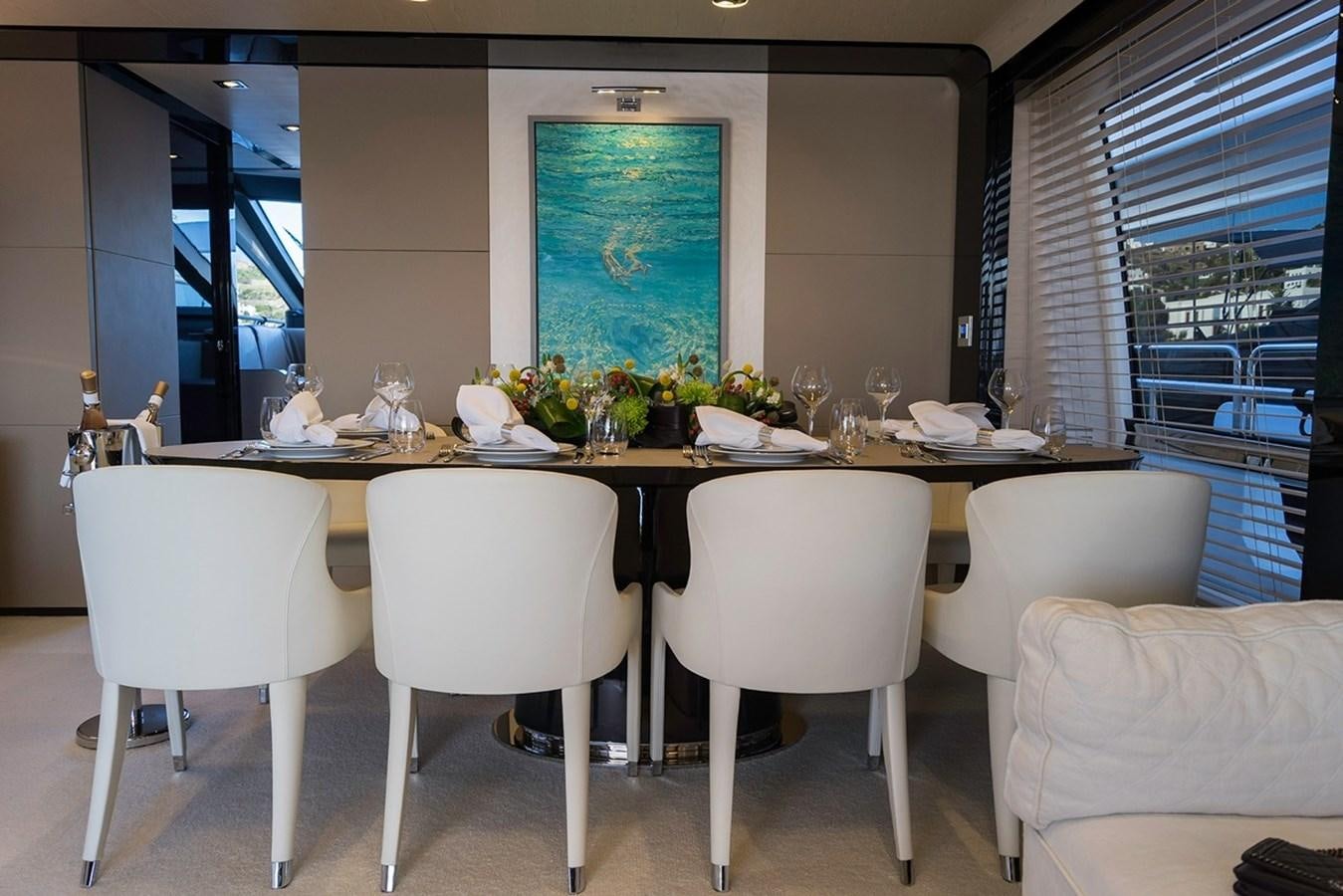 a large table with white chairs aboard MEMORIES Yacht for Sale
