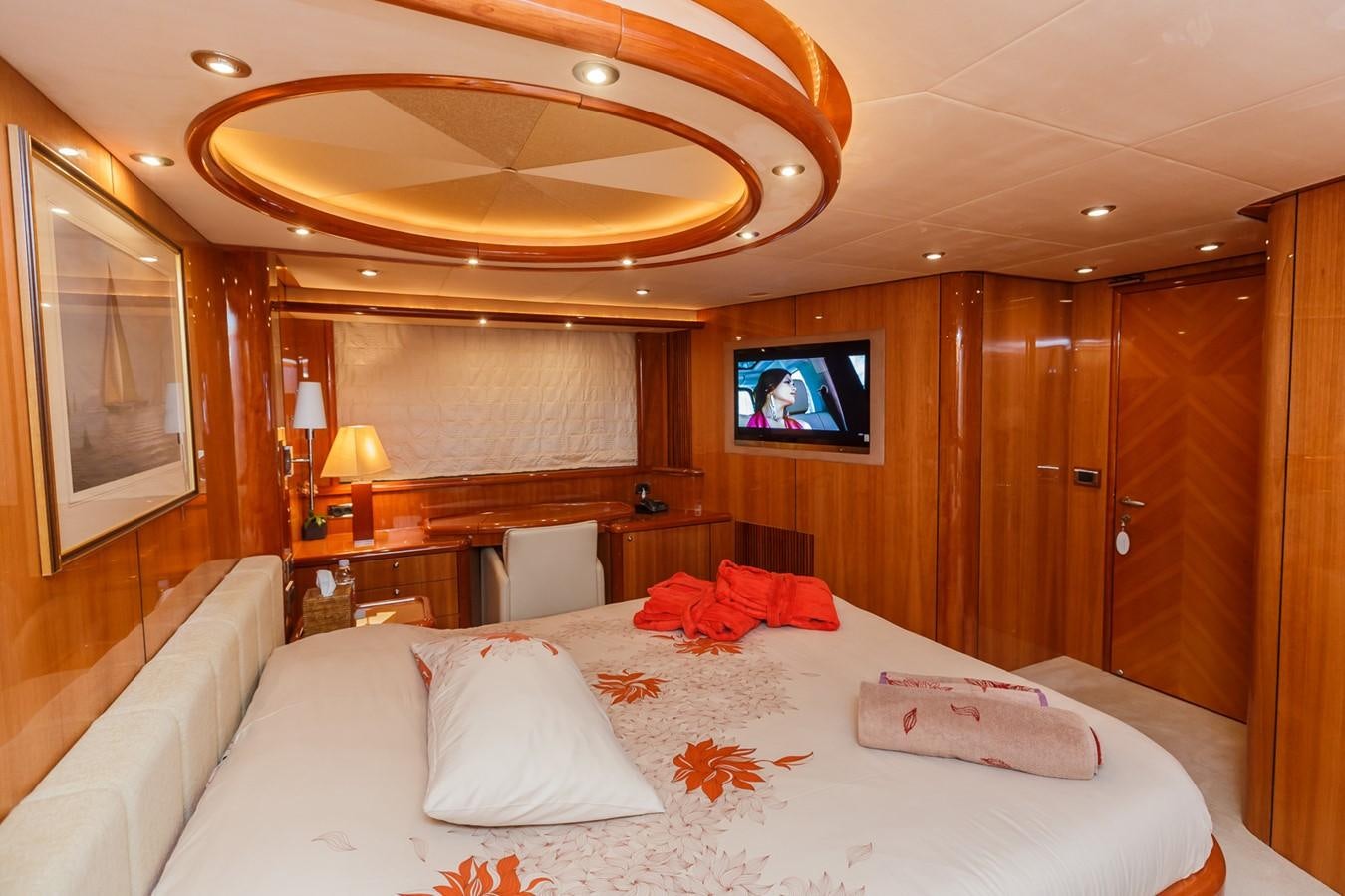 a hotel room with a bed and a tv aboard BASYA NICOLI Yacht for Sale