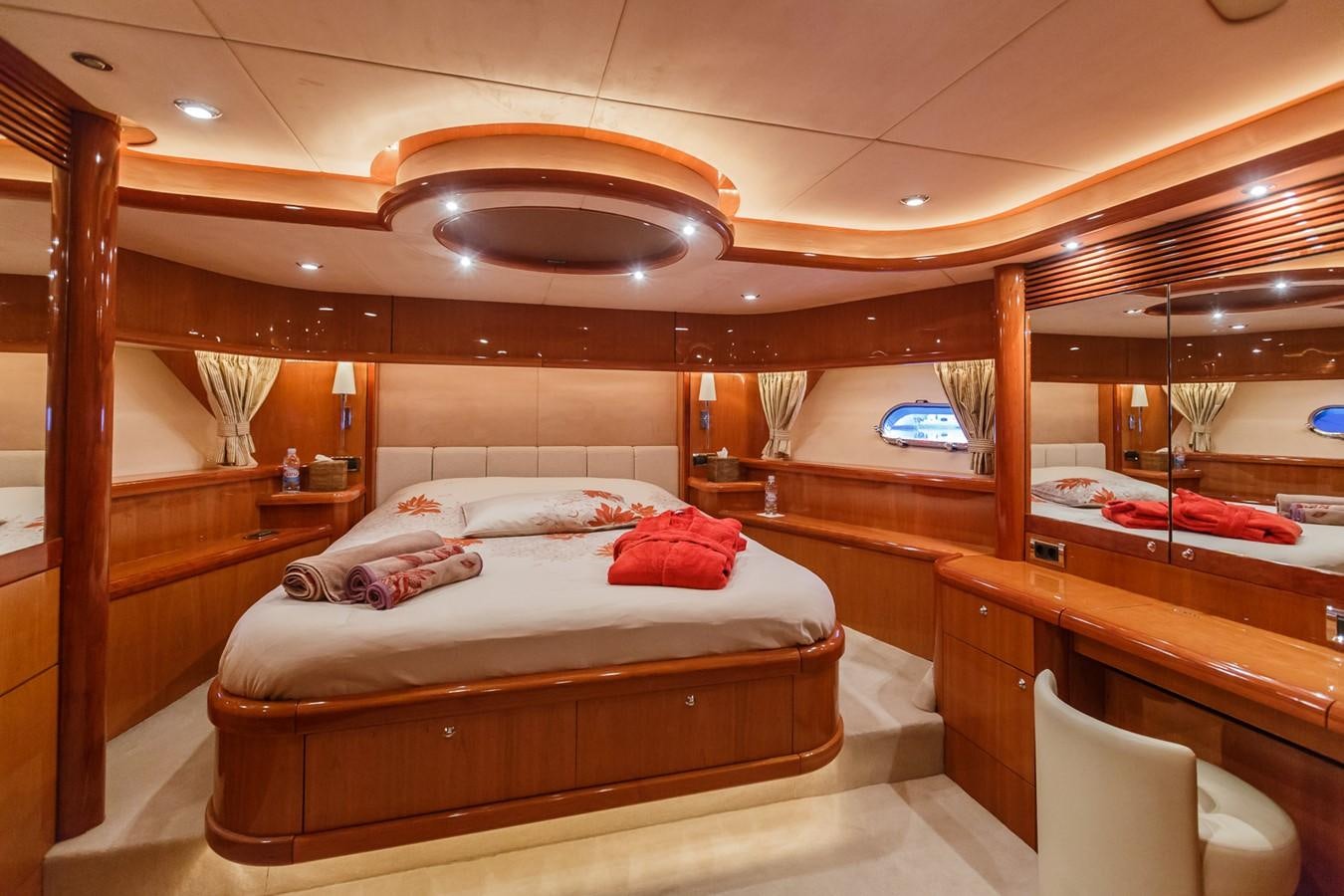 a room with a bed and a chair aboard BASYA NICOLI Yacht for Sale