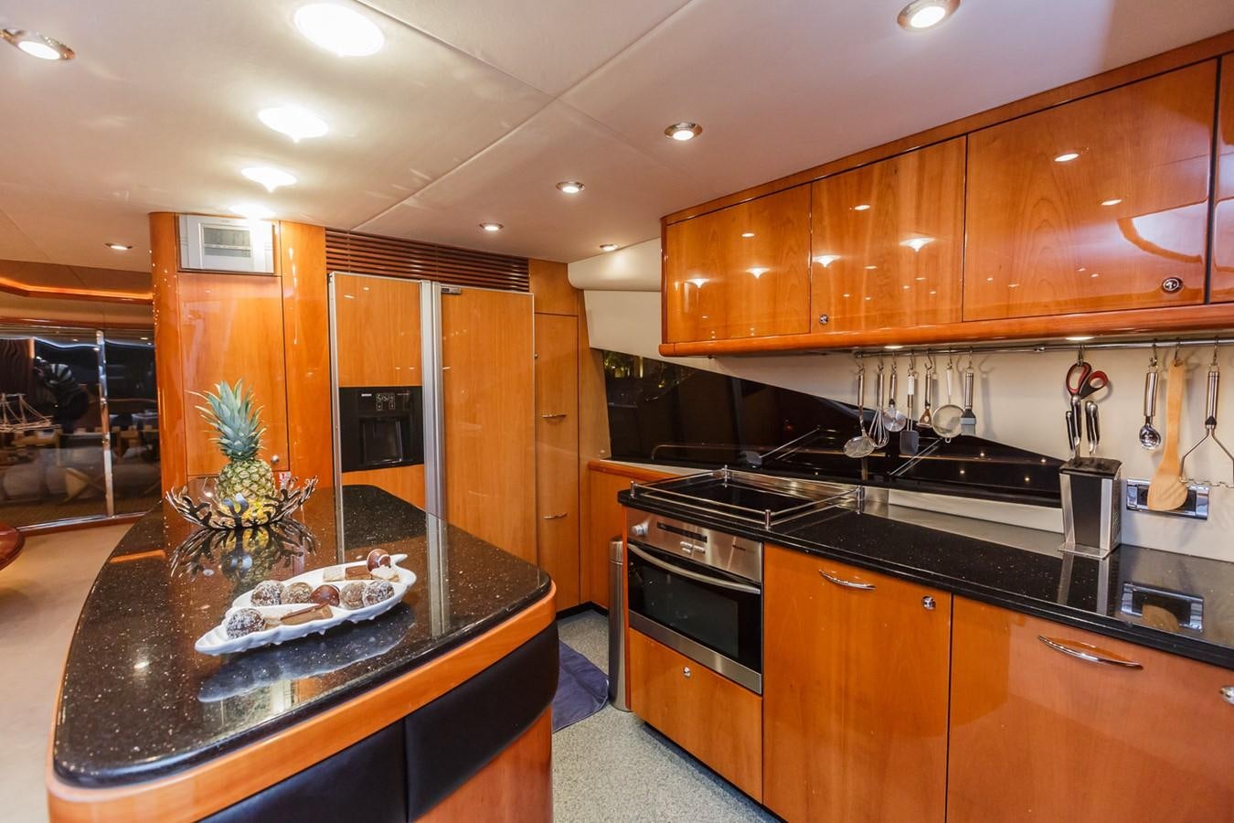 a kitchen with wooden cabinets aboard BASYA NICOLI Yacht for Sale