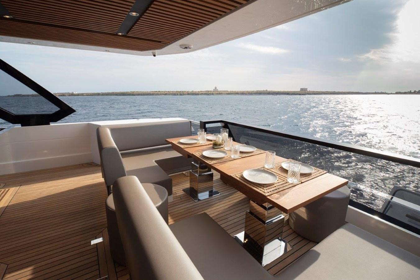 a table on a deck overlooking a large body of water aboard 2021 ASTONDOA AS8 Yacht for Sale
