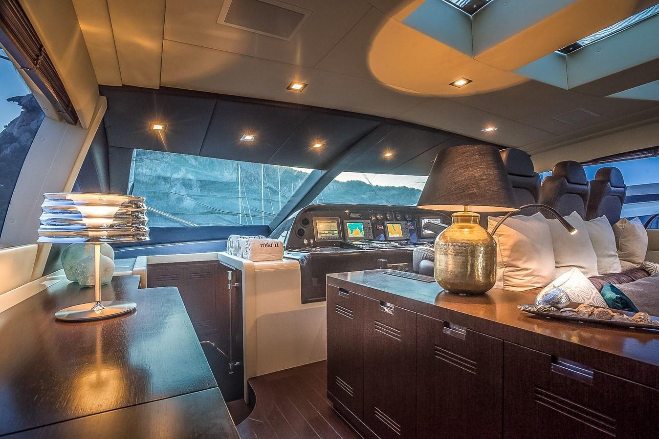 a room with a table and a lamp aboard MILU II Yacht for Sale