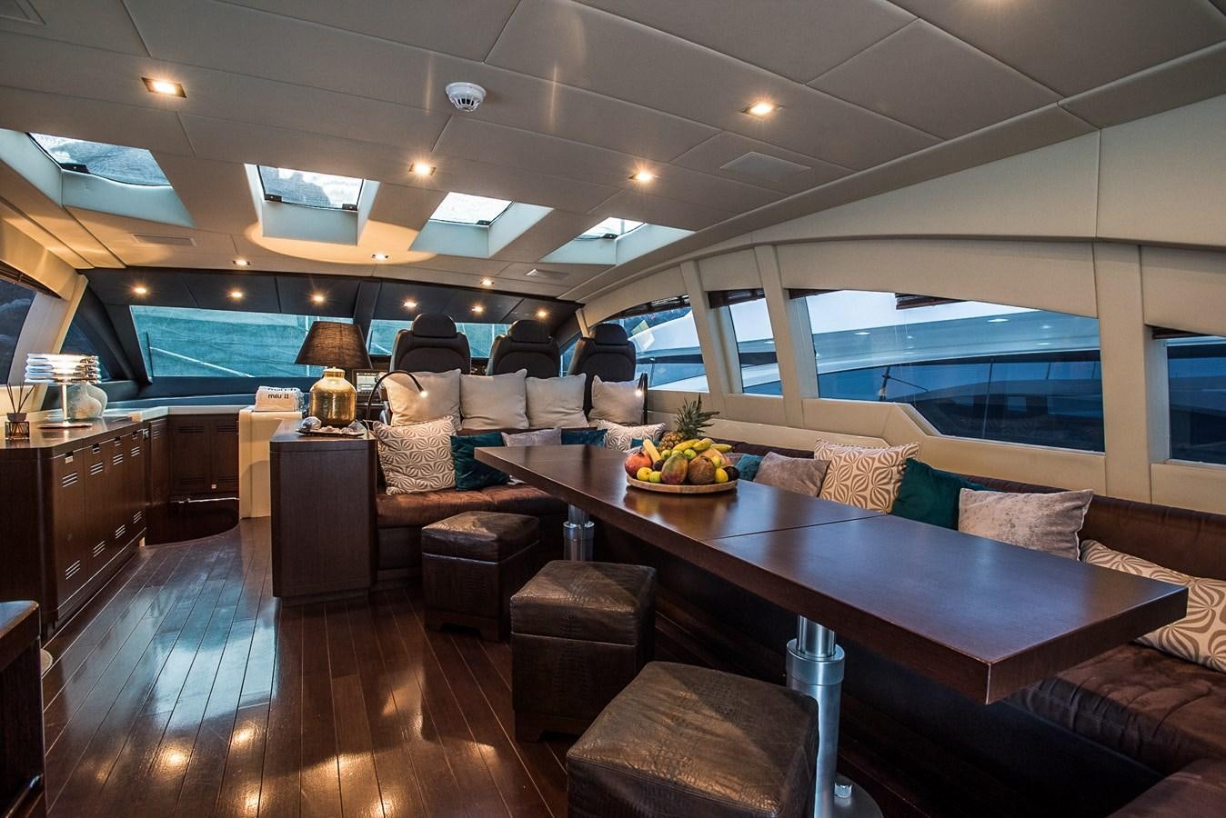 a living room with a table and couches aboard MILU II Yacht for Sale