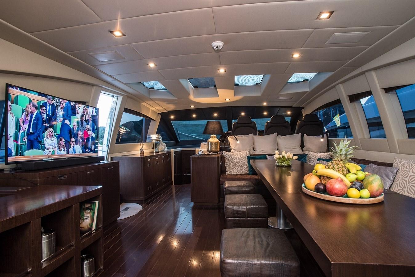 a living room with a large screen aboard MILU II Yacht for Sale