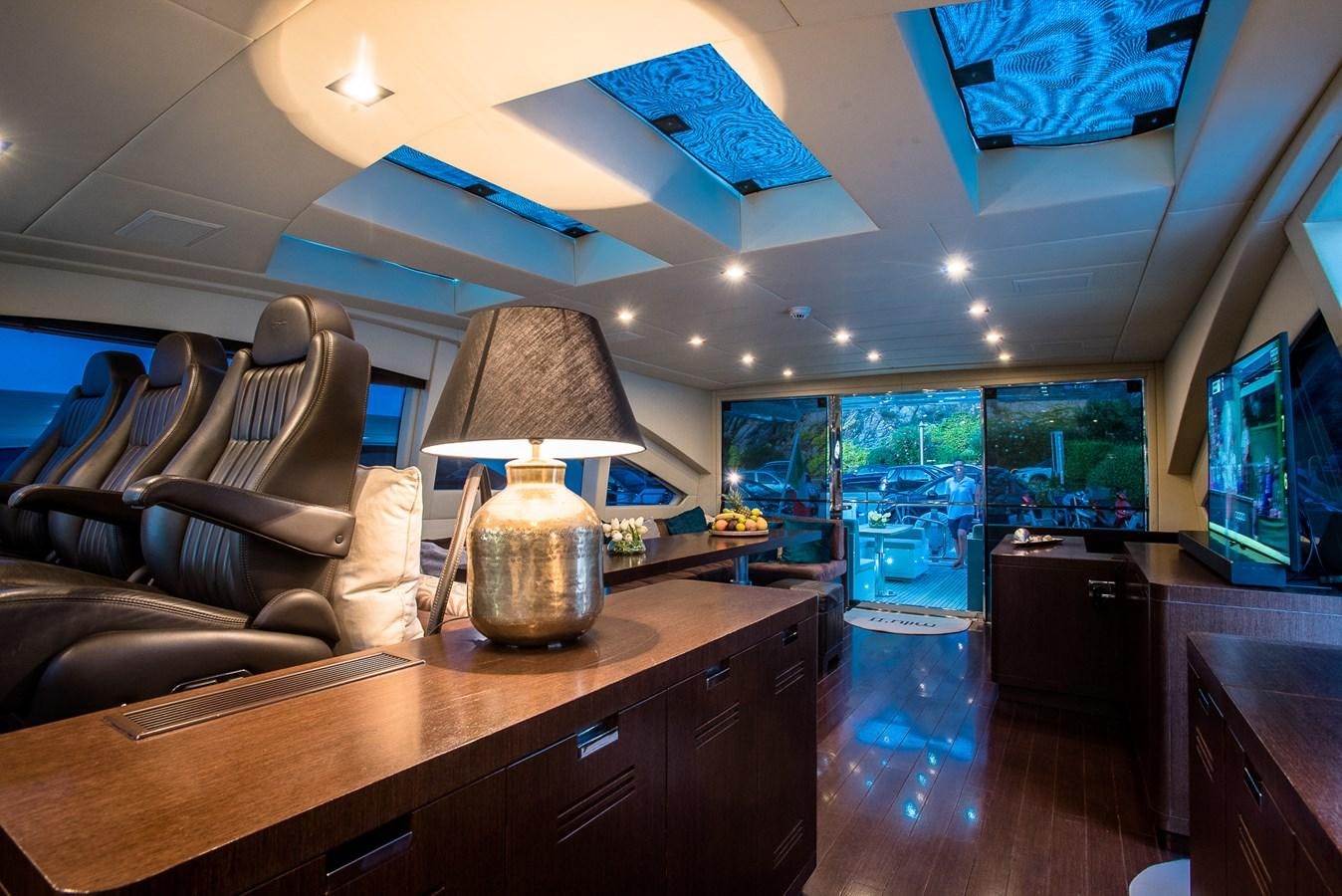 a living room with a large glass window and a large fish tank aboard MILU II Yacht for Sale