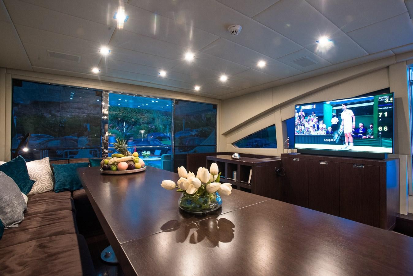 a large room with a tv and fruit on the table aboard MILU II Yacht for Sale