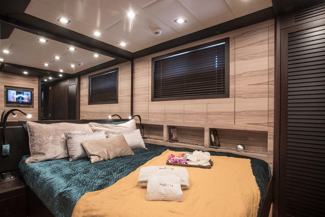 a large living room with a large bed and a table aboard MILU II Yacht for Sale