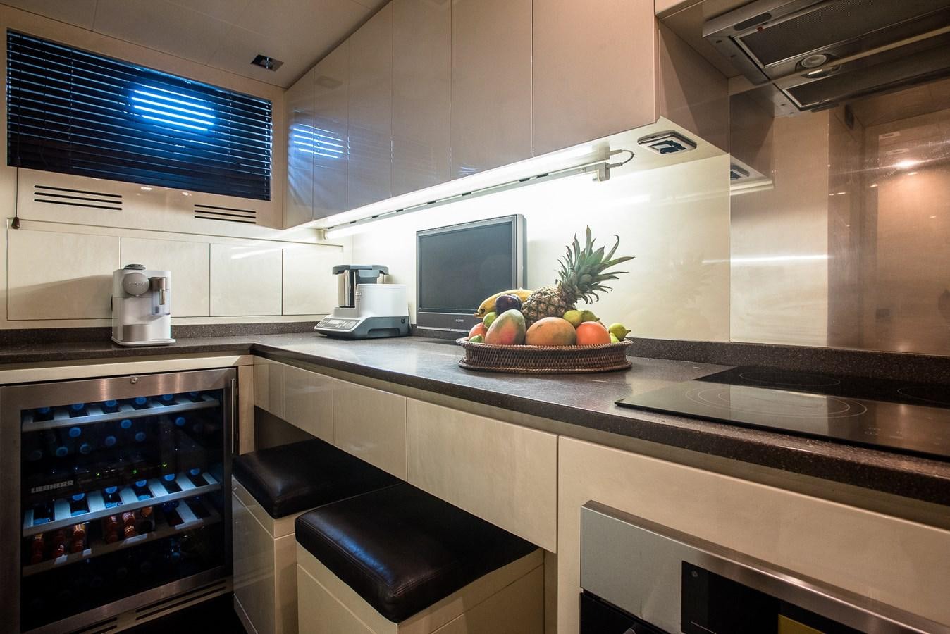 a kitchen with a bowl of fruit aboard MILU II Yacht for Sale