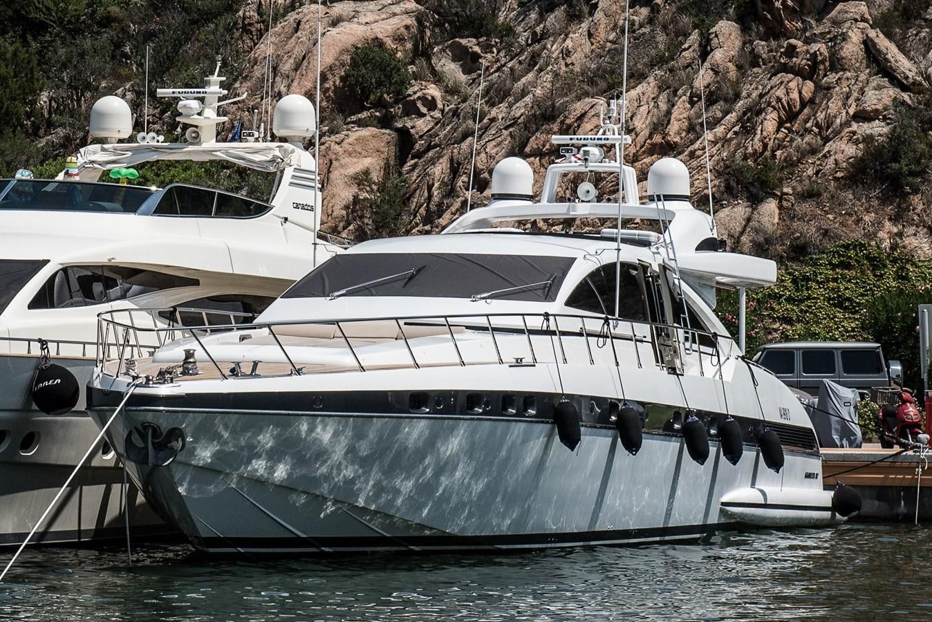 a group of boats are parked in a harbor aboard MILU II Yacht for Sale