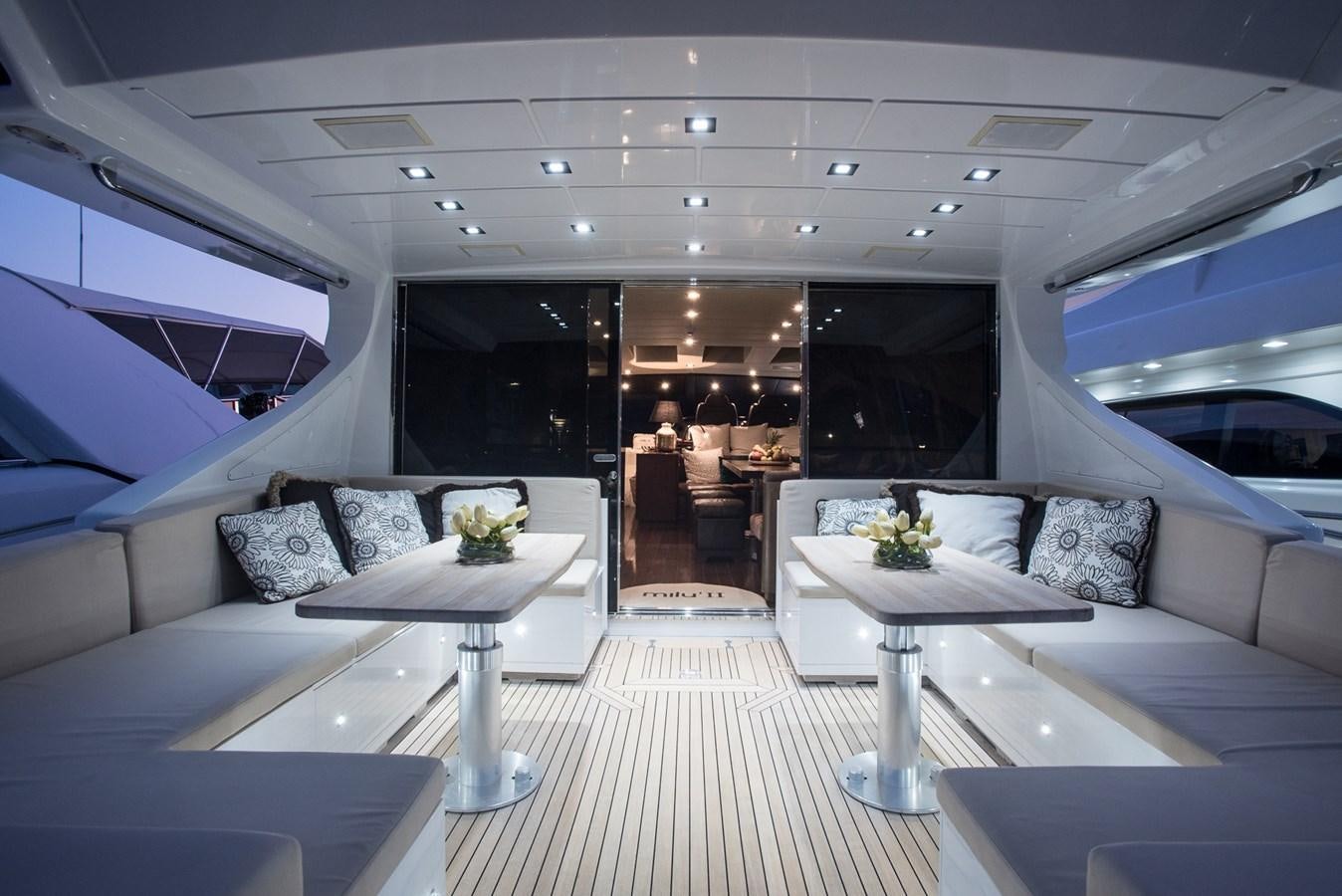 a room with a table and couches aboard MILU II Yacht for Sale