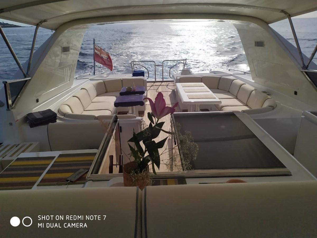 a boat with a flag on the deck aboard EL VIP ONE Yacht for Sale