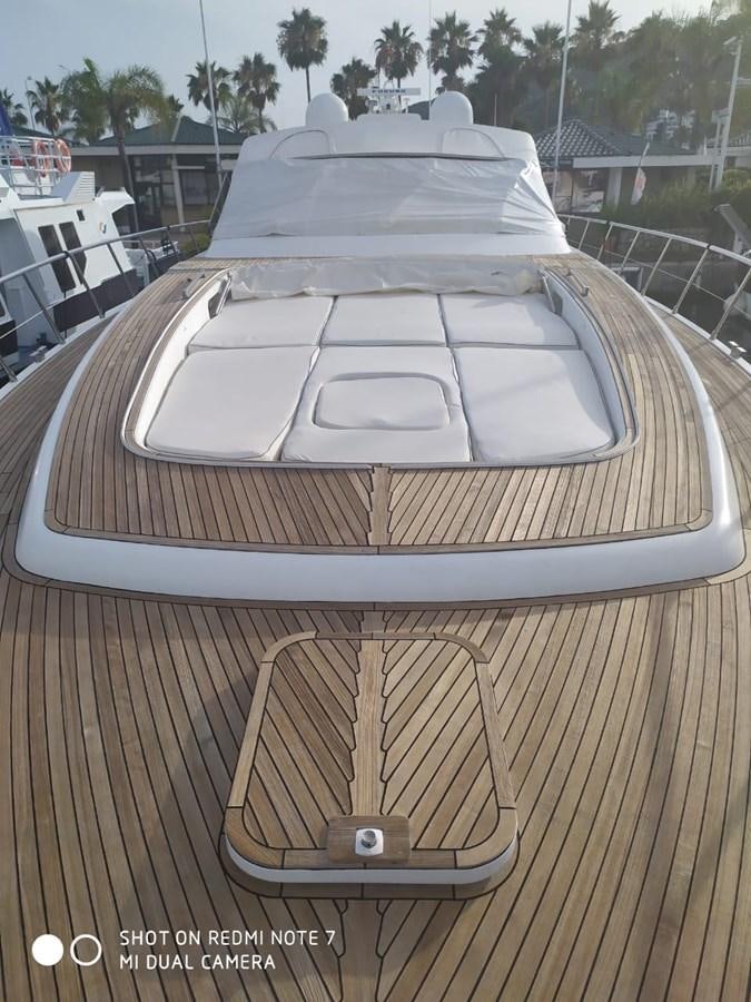 a deck with a table and chairs aboard EL VIP ONE Yacht for Sale