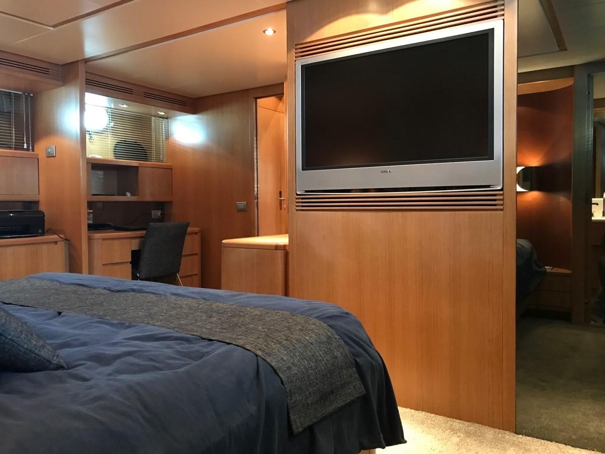 a bedroom with a tv and a bed aboard LADY LO OF LONDON Yacht for Sale