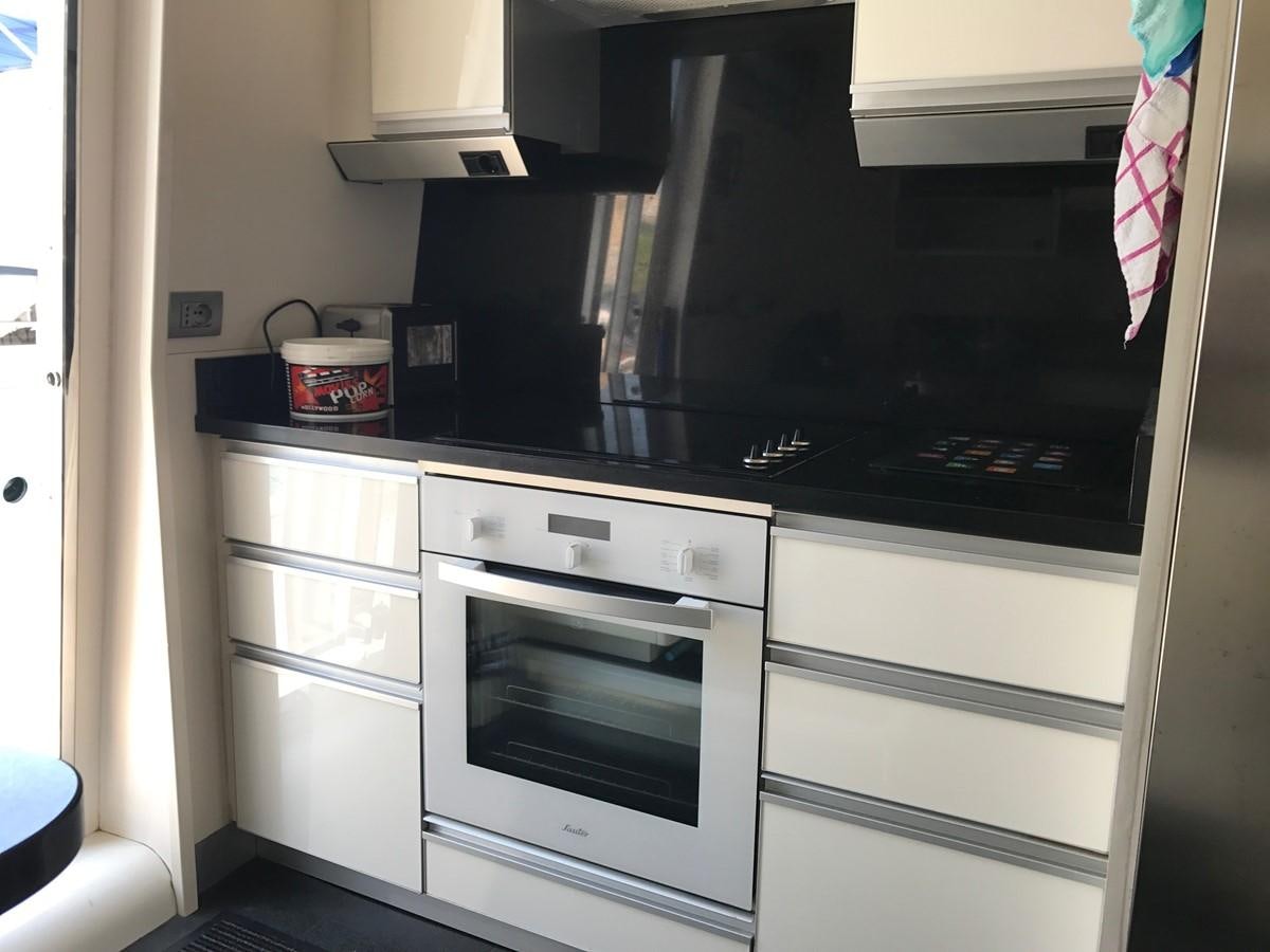 a kitchen with white cabinets aboard LADY LO OF LONDON Yacht for Sale