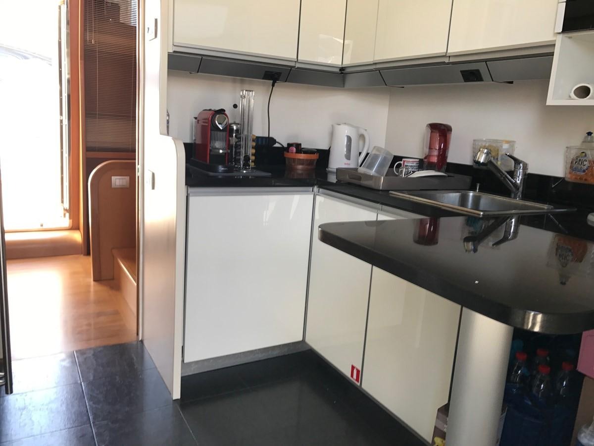 a kitchen with white cabinets aboard LADY LO OF LONDON Yacht for Sale