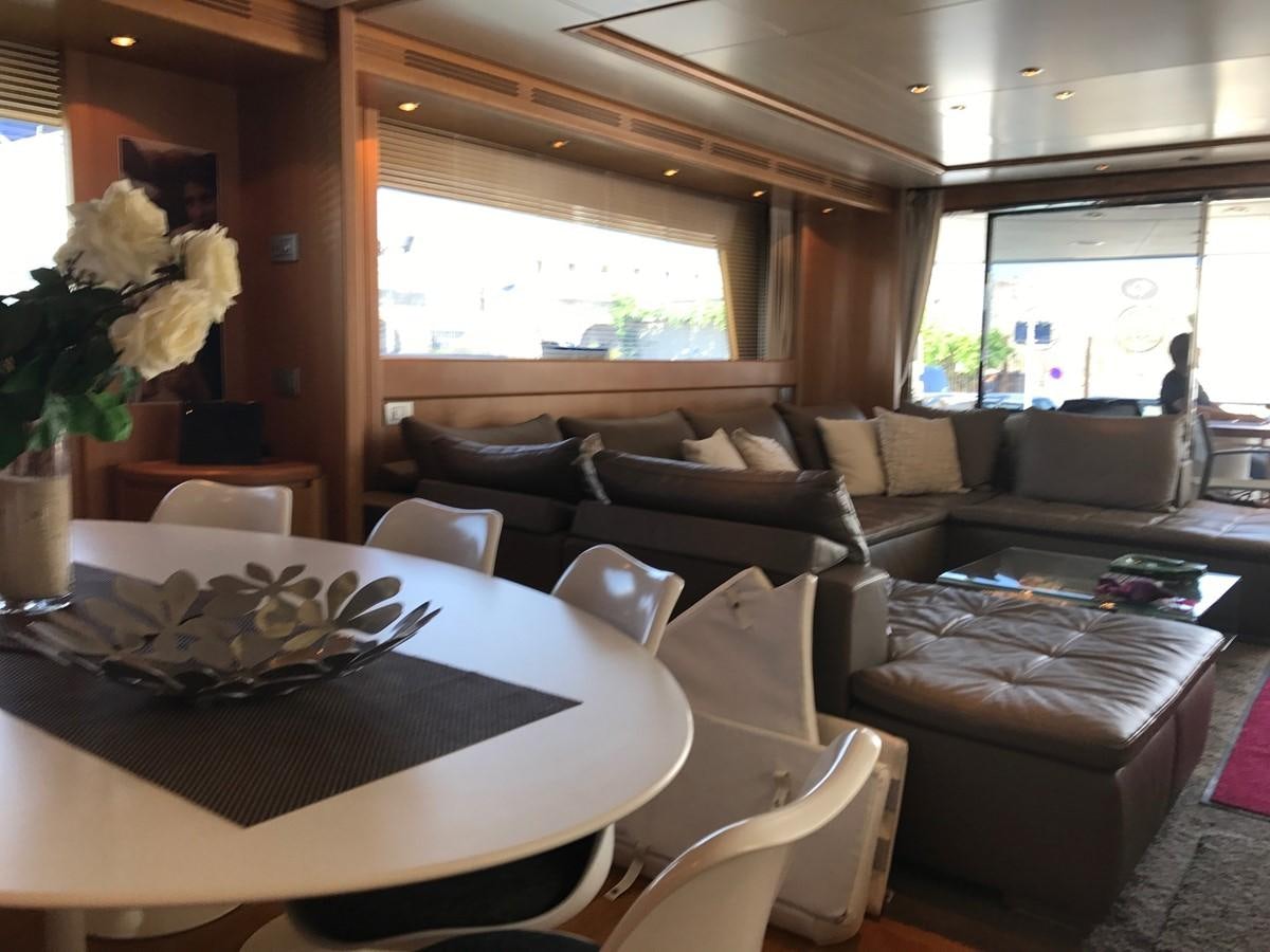 a living room with a table and couches aboard LADY LO OF LONDON Yacht for Sale