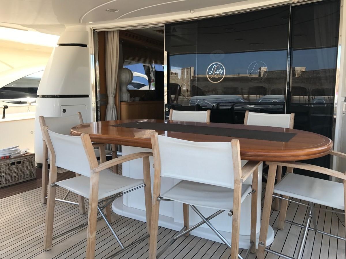 a table and chairs in a room aboard LADY LO OF LONDON Yacht for Sale
