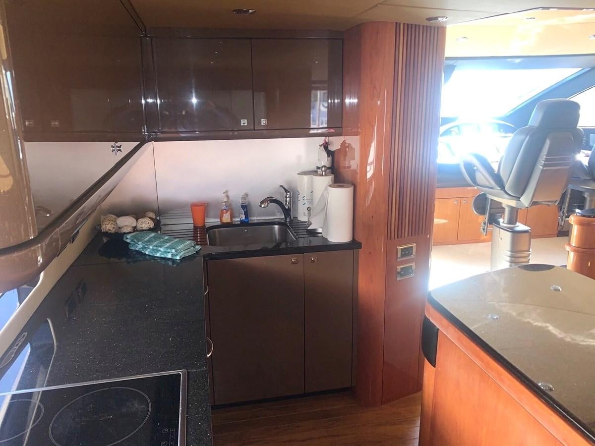 a kitchen with black appliances aboard MY MEDICINE Yacht for Sale