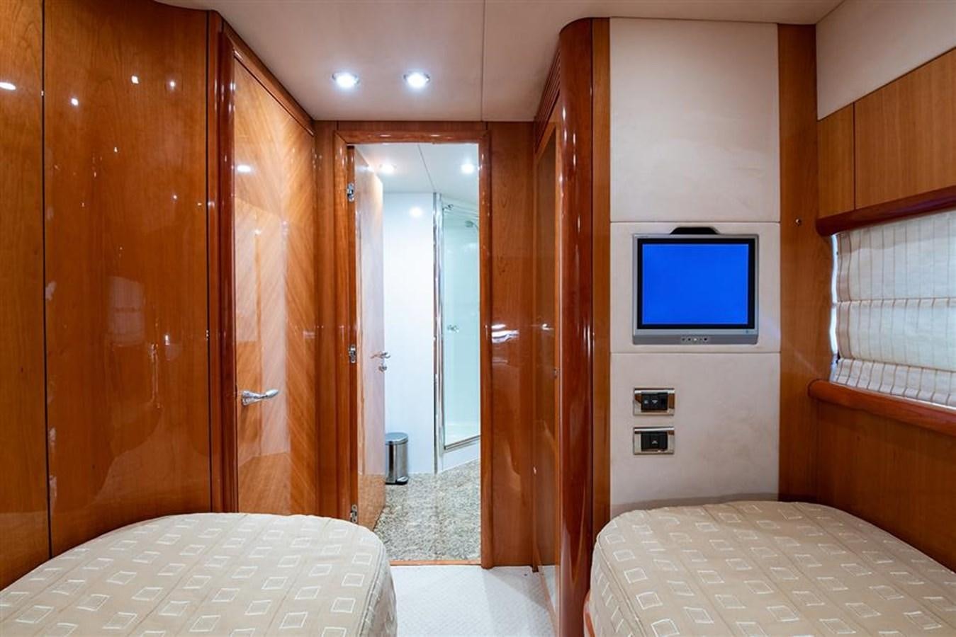 a bedroom with a tv on the wall aboard MY MEDICINE Yacht for Sale