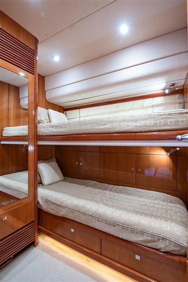 a bunk bed with a wooden headboard aboard MY MEDICINE Yacht for Sale