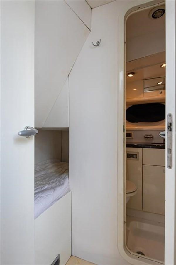 a small bathroom with a white door aboard MY MEDICINE Yacht for Sale