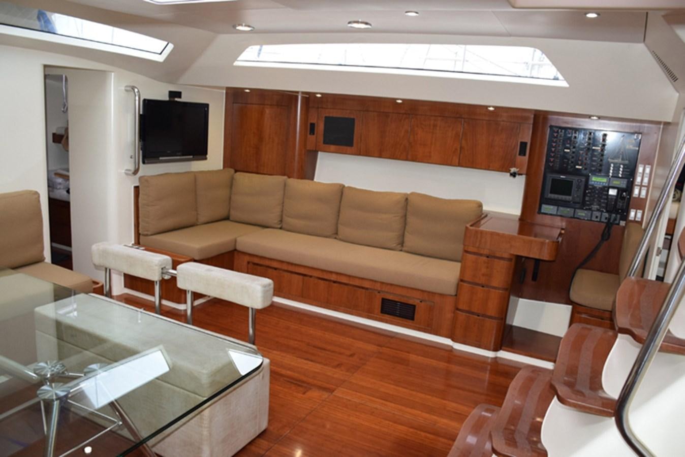 a living room with a couch and a television aboard WHITE DUMBO Yacht for Sale