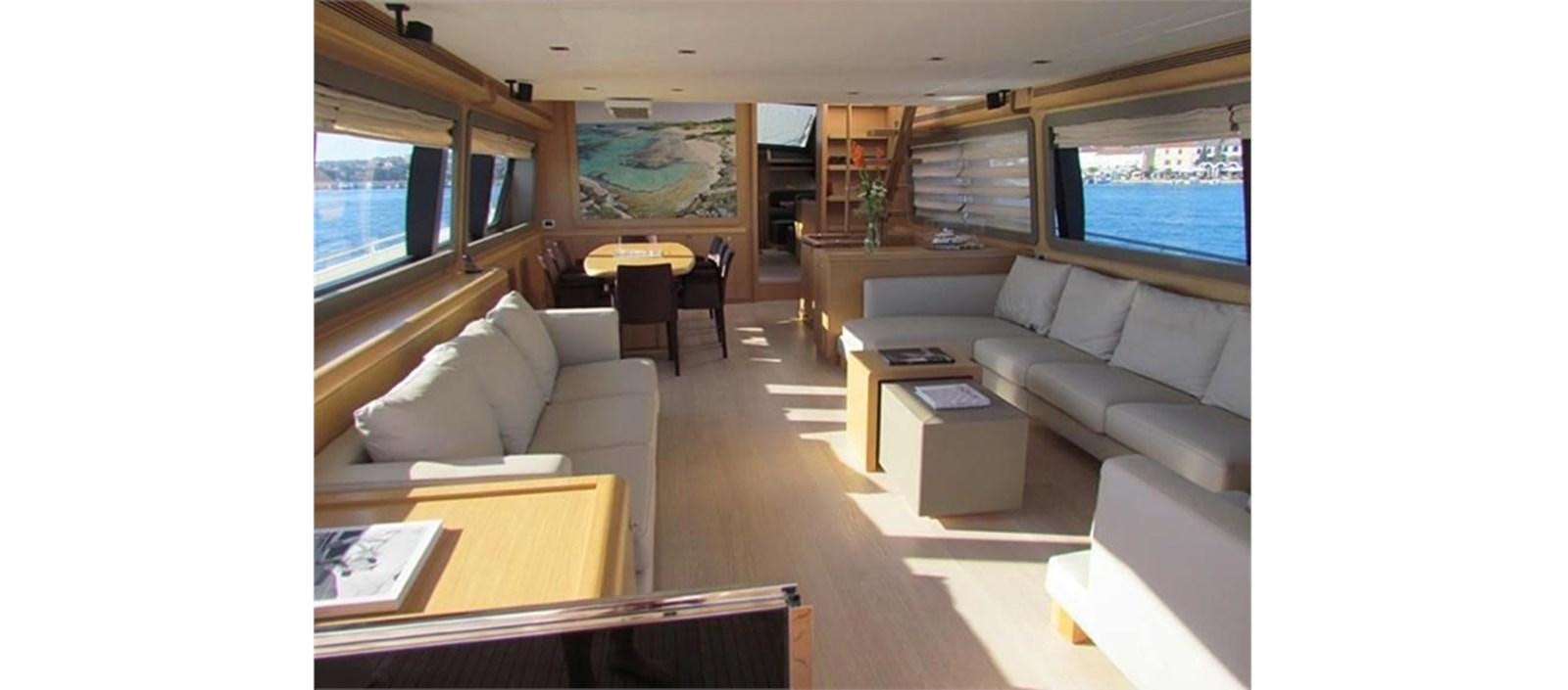 a living room with a couch and a table aboard LA STELLA Yacht for Sale