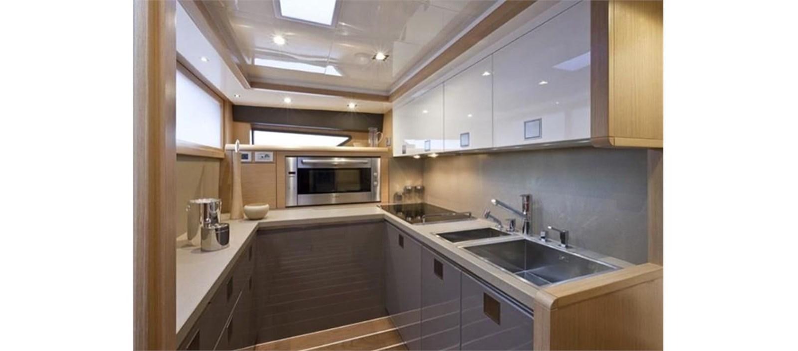 a kitchen with a sink and microwave aboard LA STELLA Yacht for Sale