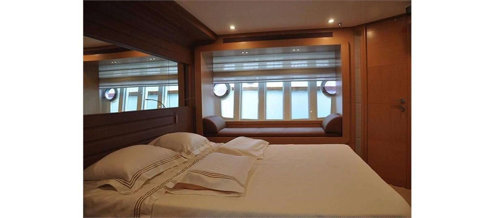a room with a bed and a window aboard LA STELLA Yacht for Sale