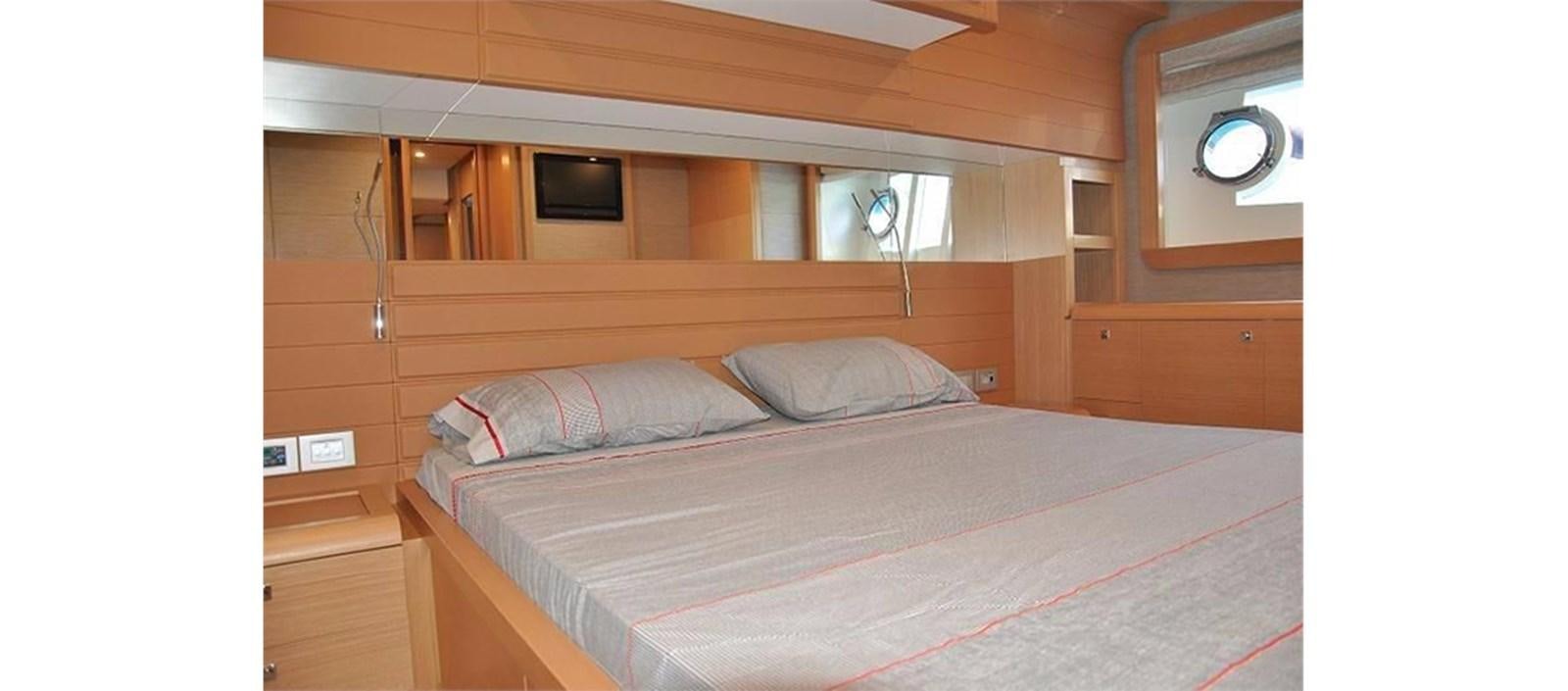 a room with a bed and a television aboard LA STELLA Yacht for Sale