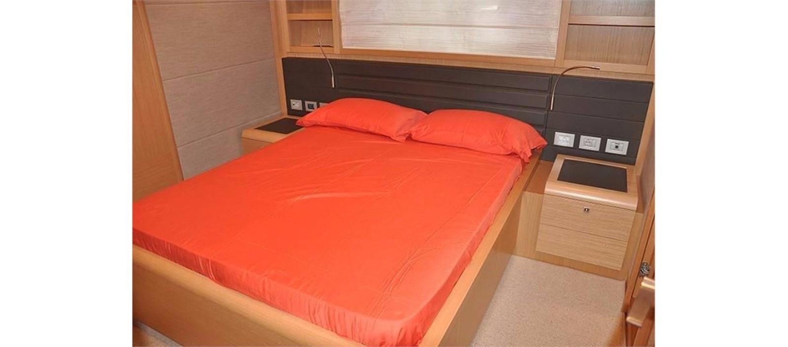 a bed with red sheets aboard LA STELLA Yacht for Sale