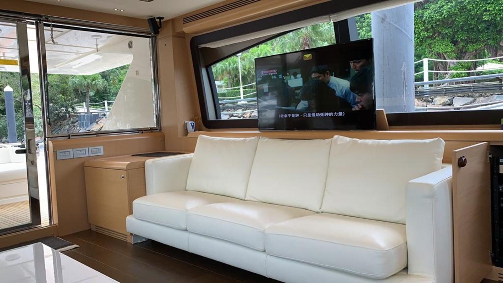 a white couch in a room aboard FERRETTI F800/27 Yacht for Sale