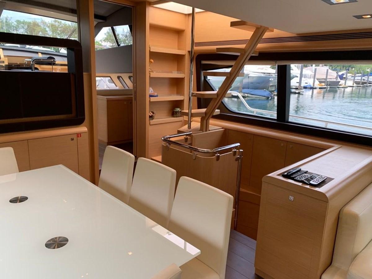 a room with a table and chairs aboard FERRETTI F800/27 Yacht for Sale