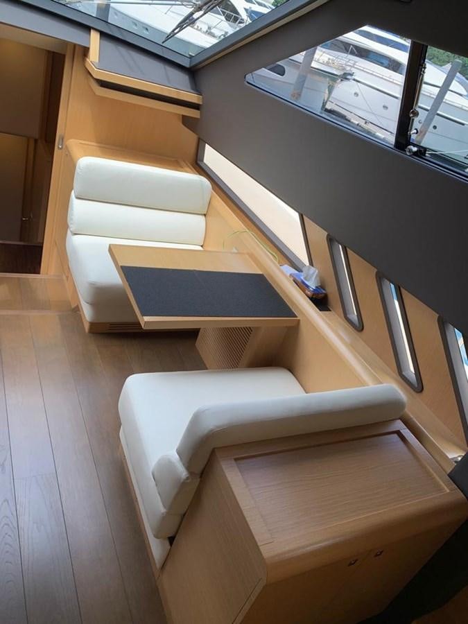 a room with a couch and a table aboard FERRETTI F800/27 Yacht for Sale