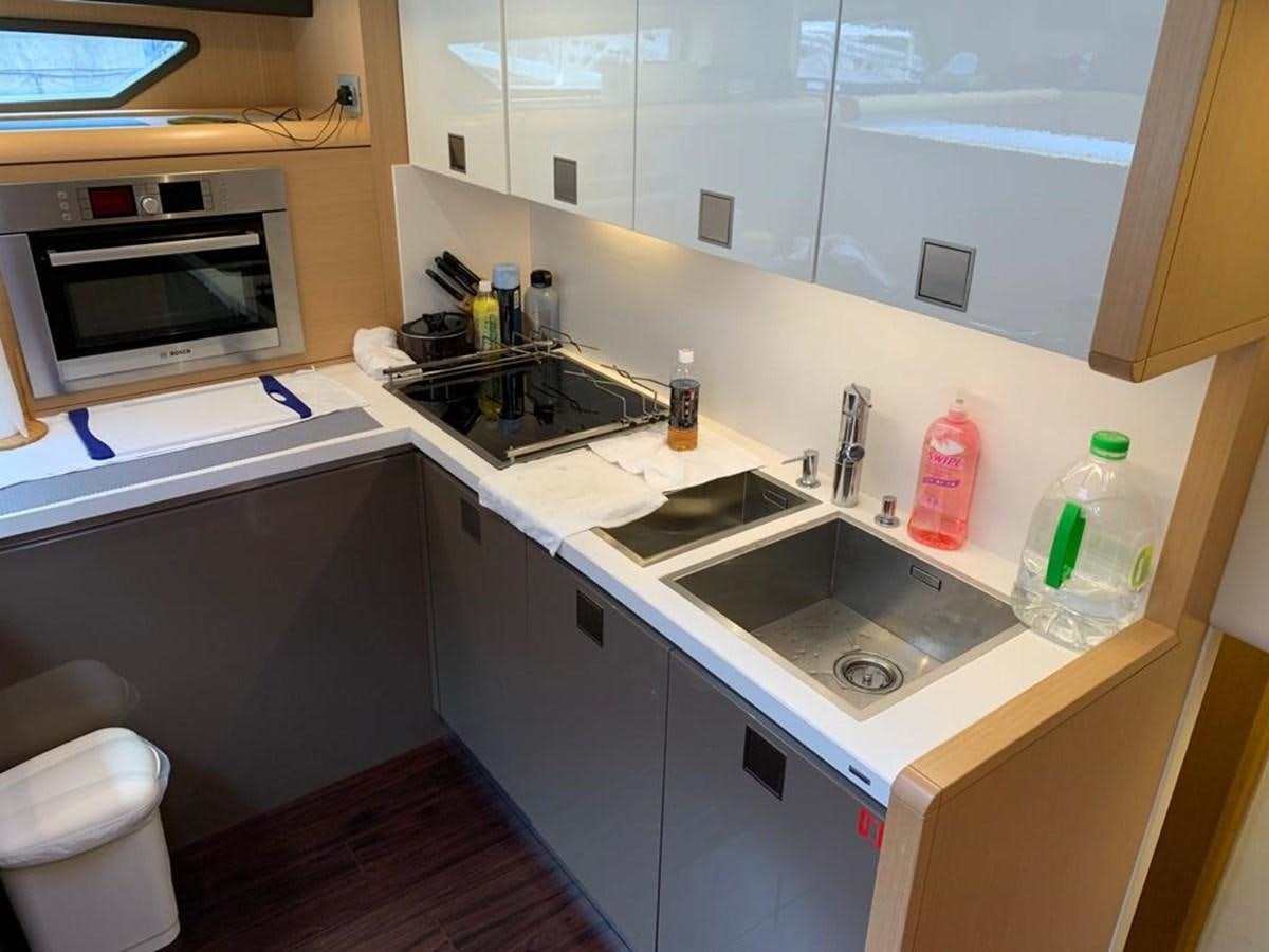 a kitchen with a sink and a microwave aboard FERRETTI F800/27 Yacht for Sale