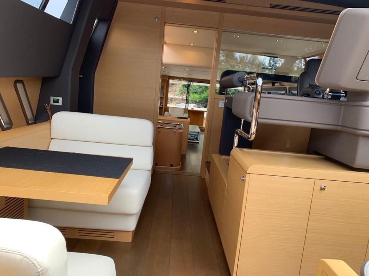 a room with a bed and desk aboard FERRETTI F800/27 Yacht for Sale