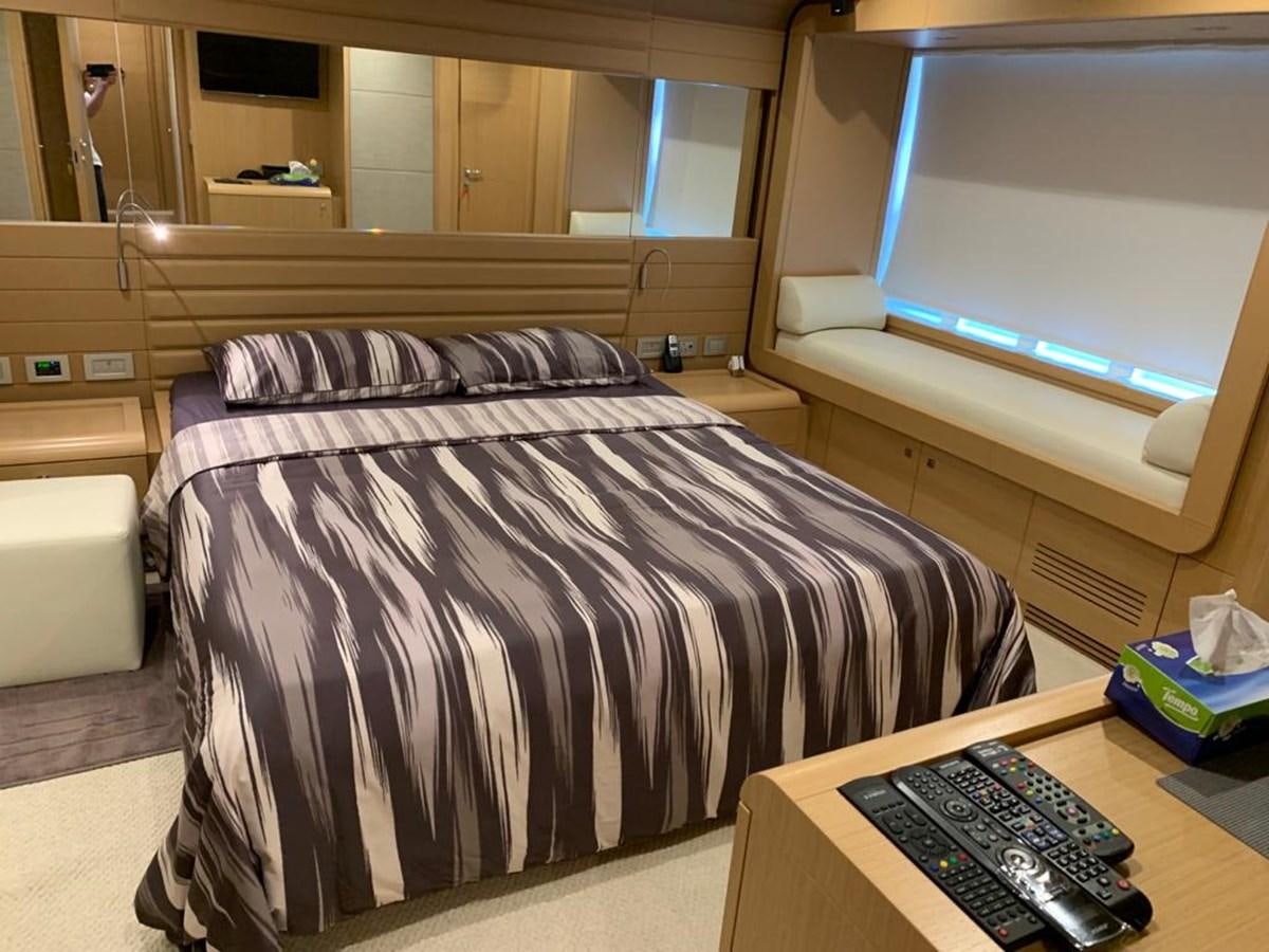 a bed with a television on the wall aboard FERRETTI F800/27 Yacht for Sale