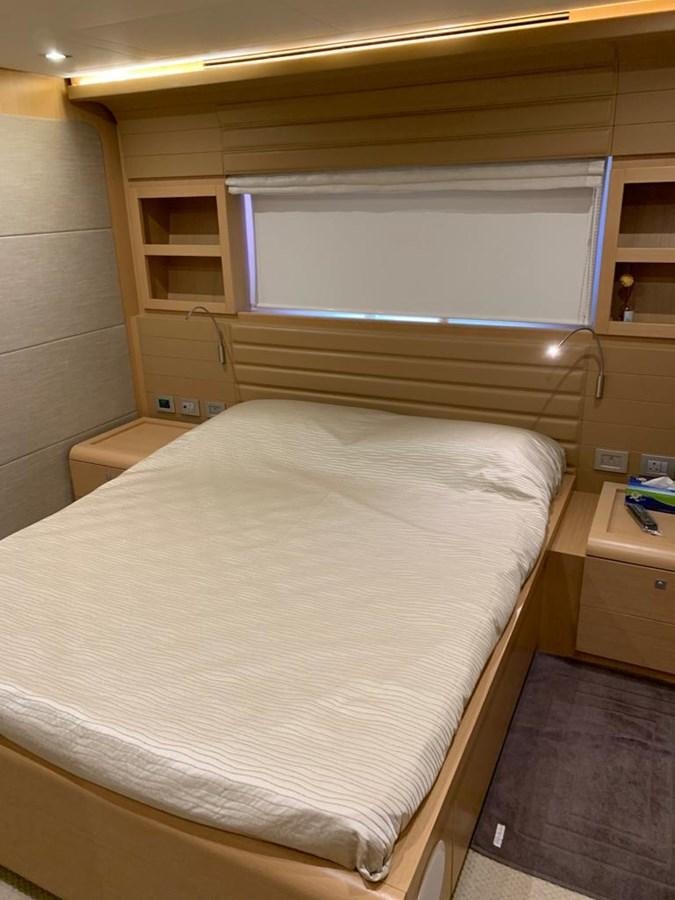 a bed with a white sheet aboard FERRETTI F800/27 Yacht for Sale