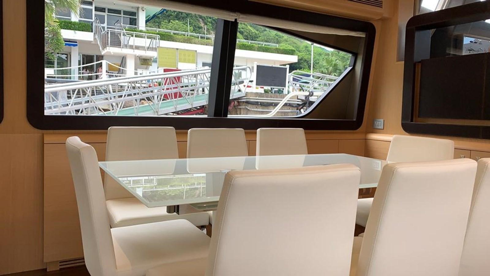 a room with a table and chairs aboard FERRETTI F800/27 Yacht for Sale