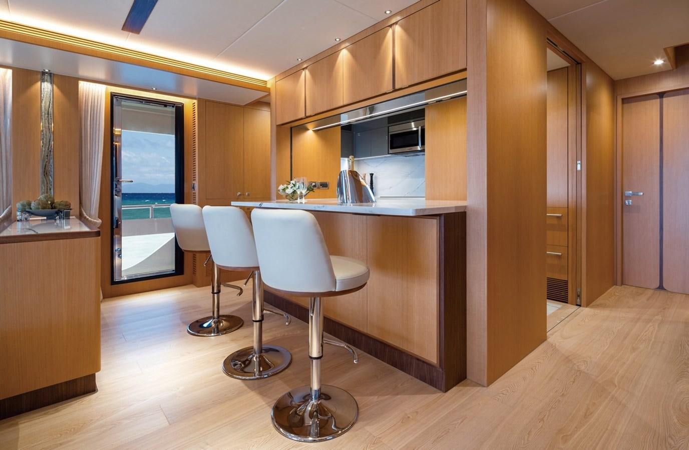a kitchen with a table and chairs aboard FD80 SKYLINE (NEW BOAT SPEC ) Yacht for Sale