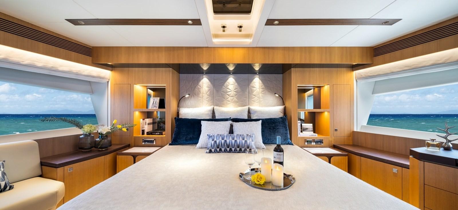 a room with a bed and a table with a bottle of wine aboard FD80 SKYLINE (NEW BOAT SPEC ) Yacht for Sale