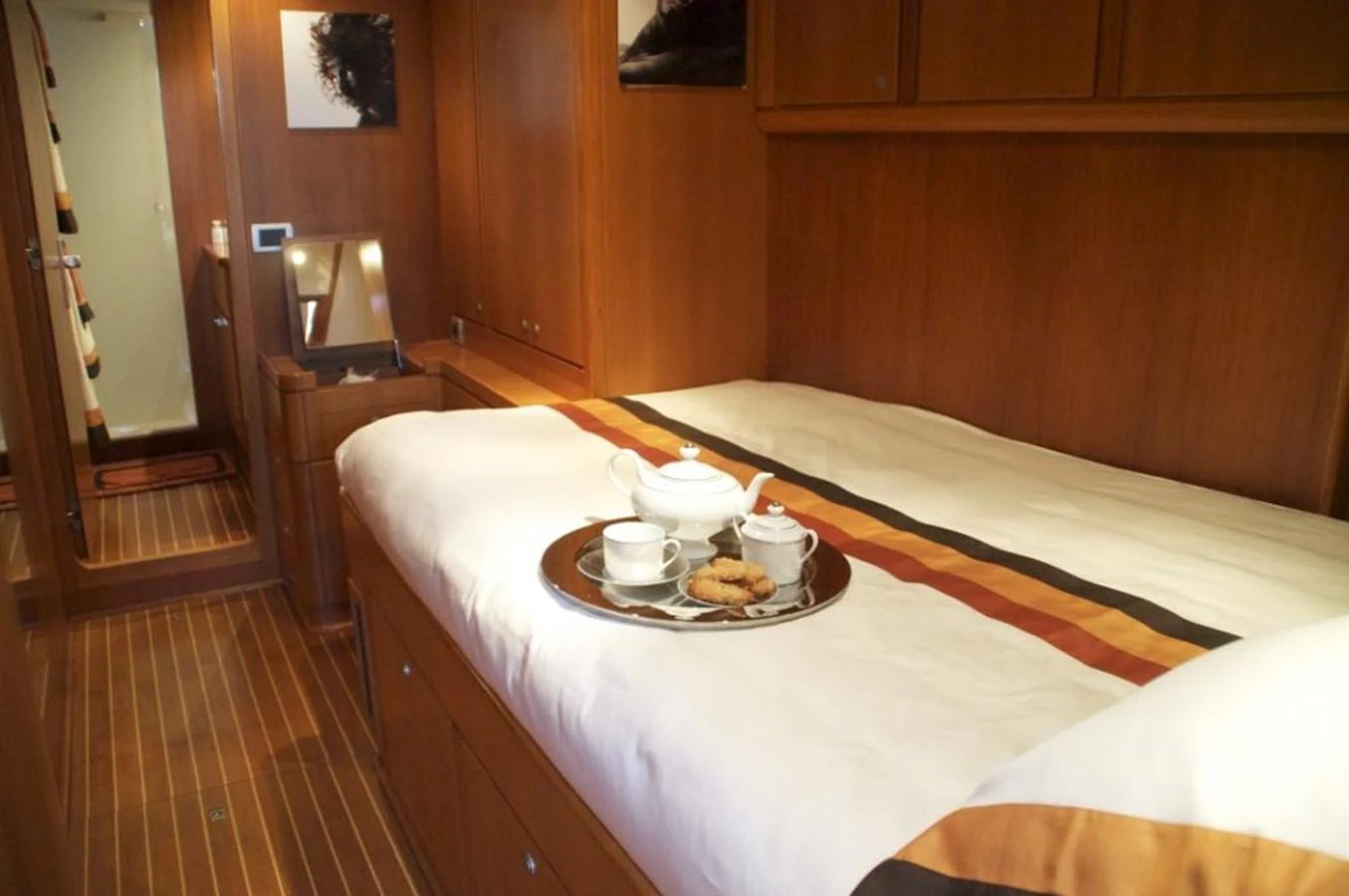 a bed with a tray of food on it aboard VOLADOR Yacht for Sale